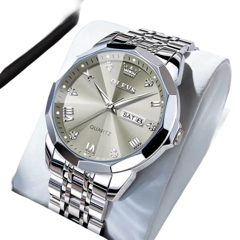 Montre à quartz pour homme, de couleur argentée, avec affichage de la date du jour, lunette à facettes multiples, index en chiffres romains et en diamants, et bracelet à maillons en métal.